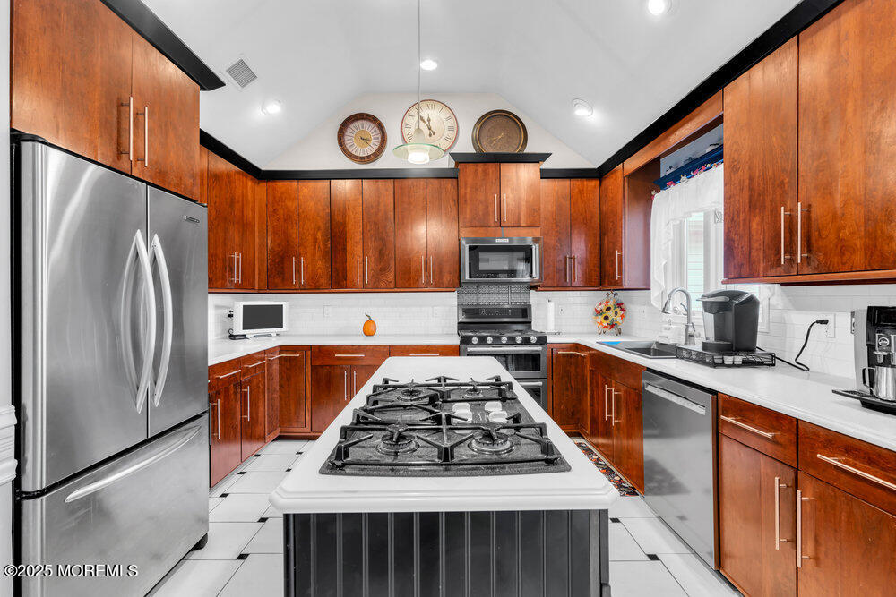 117 South Cooks Bridge Road Jackson, NJ 08527 - Photo 23 of 48 a kitchen with wooden cabinets stainless steel appliances and a refrigerator
