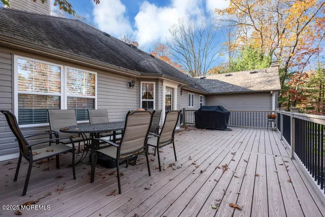 a bedroom with a bed and a flat tv screen on the dresser