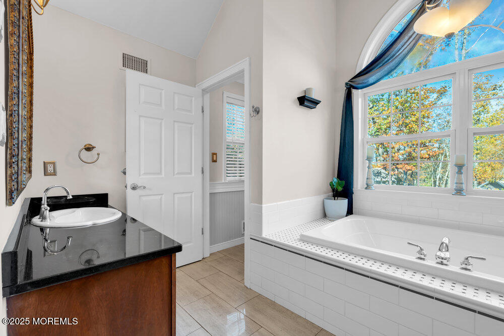 117 South Cooks Bridge Road Jackson, NJ 08527 - Photo 35 of 48 a spacious bathroom with a granite countertop tub sink and mirror