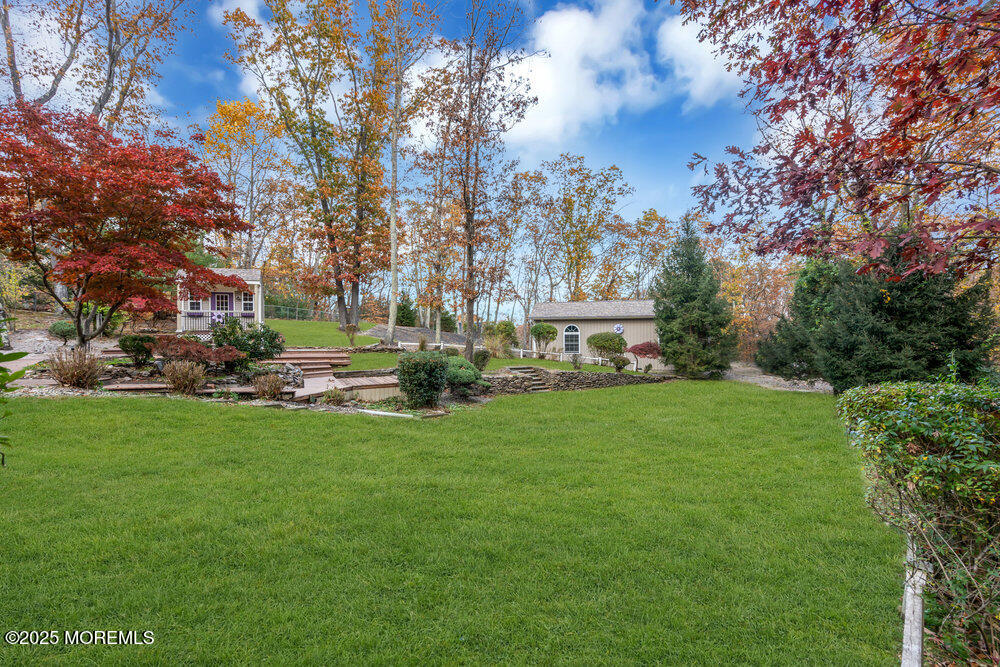 117 South Cooks Bridge Road Jackson, NJ 08527 - Photo 45 of 48 a view of a house with garden and a bench