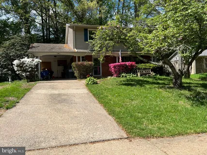 a view of house with yard outdoor entertaining spaces