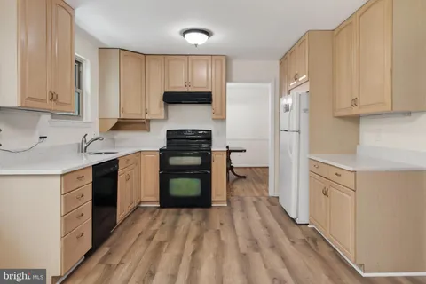 a kitchen with stainless steel appliances a refrigerator sink and cabinets