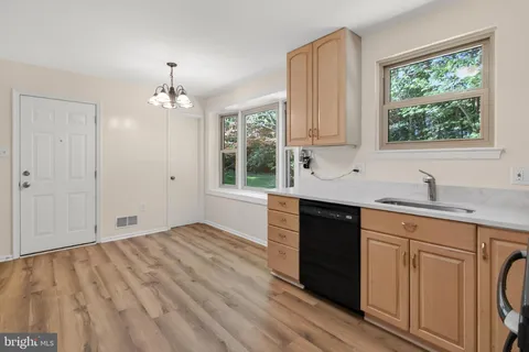 a kitchen with a sink cabinets and window