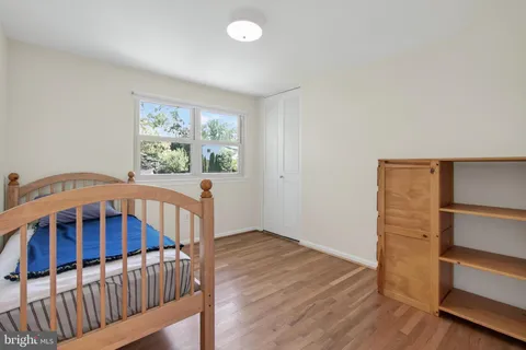 a view of a bedroom with wooden floor