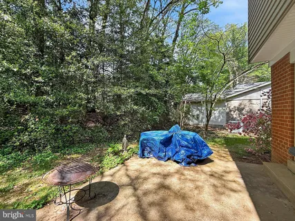 a backyard of a house with a yard and outdoor seating