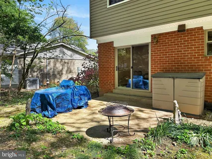 a view of a chairs and table in backyard