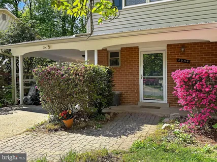 a view of a house with potted plants