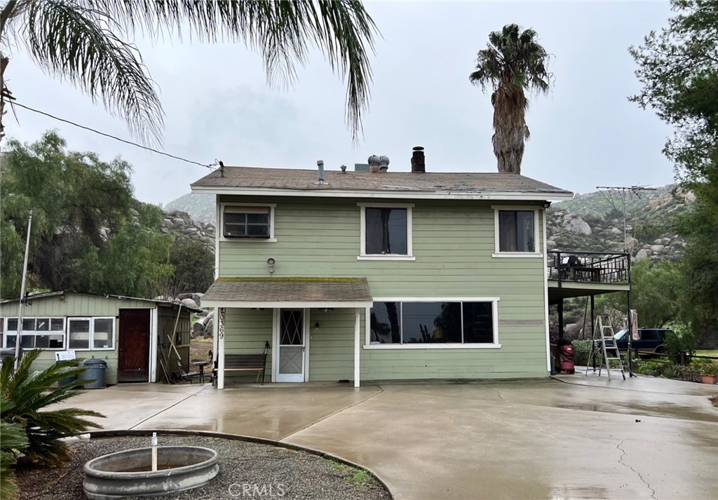 20369 Gustin Road Perris, CA 92570 - Photo 1 of 1 a front view of a house with yard and seating space