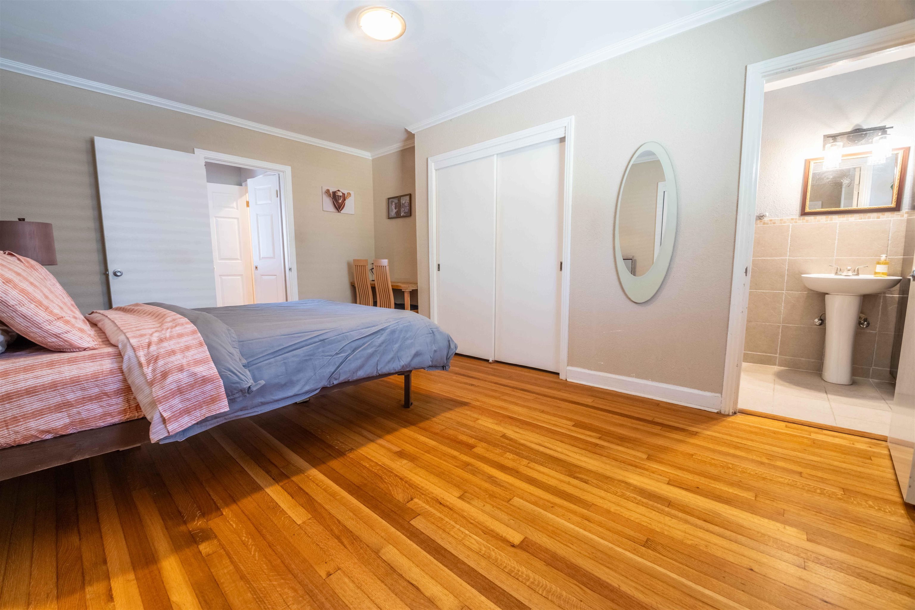 5099 Walnut Grove Road Memphis, TN 38117 - Photo 17 of 24 Bedroom with light wood-style flooring, a closet, ensuite bathroom, and crown molding