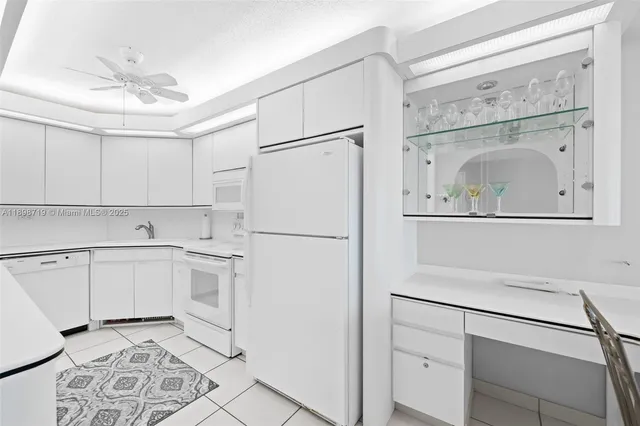 a white refrigerator freezer sitting inside of a kitchen