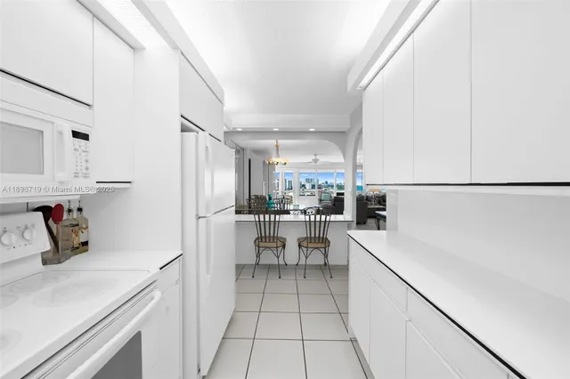 a kitchen with a sink a refrigerator and cabinets