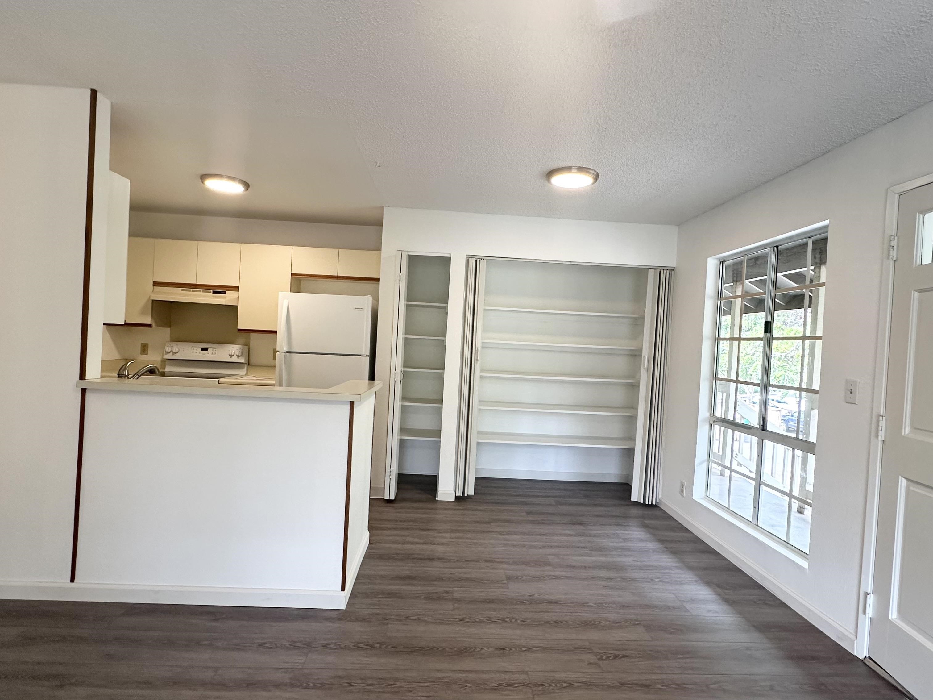 140 Uwapo Road, Unit 33201 Kihei, HI 96753 - Photo 2 of 13 a view of kitchen with wooden floor and electronic appliances