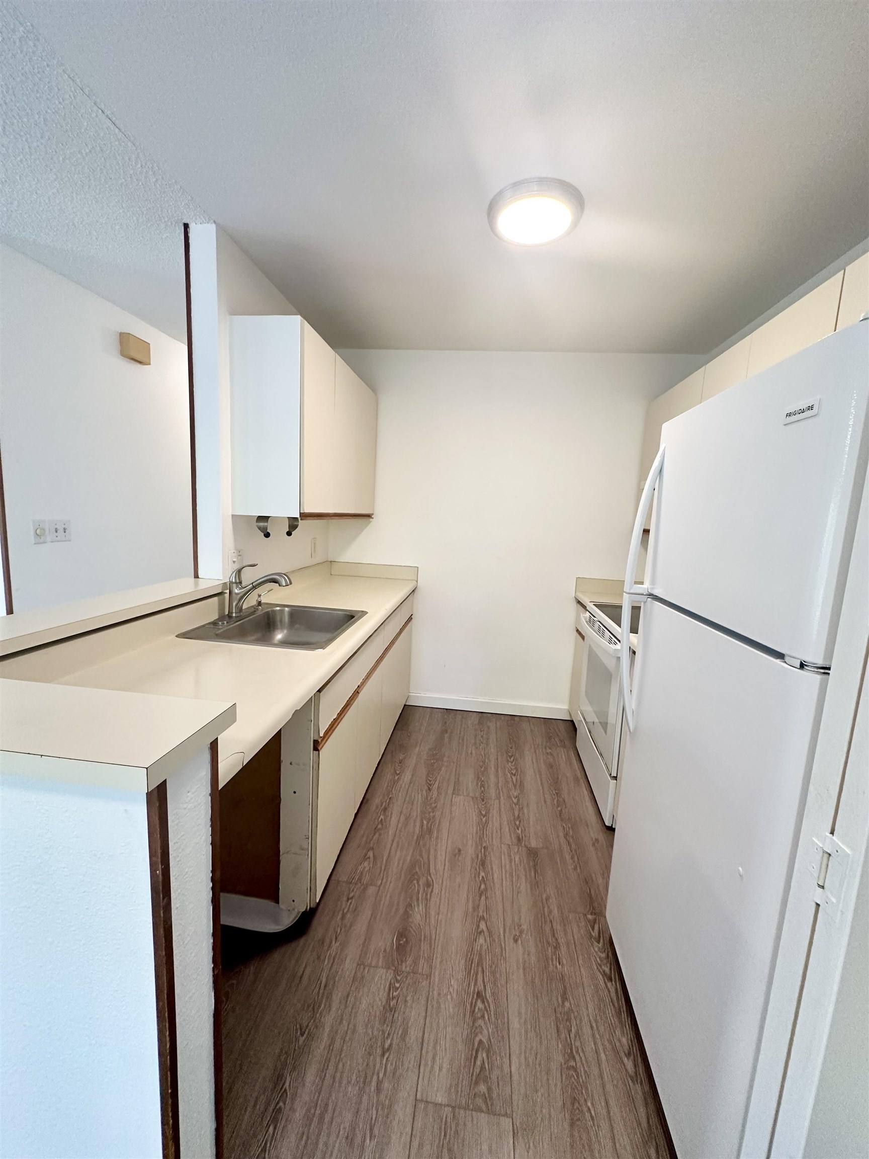 140 Uwapo Road, Unit 33201 Kihei, HI 96753 - Photo 3 of 13 a kitchen with a sink a refrigerator a washer and dryer