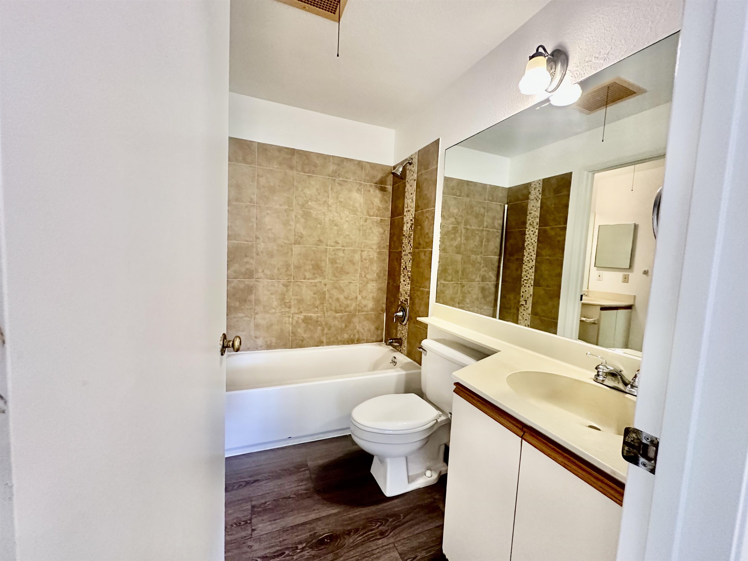140 Uwapo Road, Unit 33201 Kihei, HI 96753 - Photo 7 of 13 a bathroom with a sink a toilet a mirror and bathtub