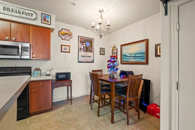 a view of a dining room with furniture and a chandelier