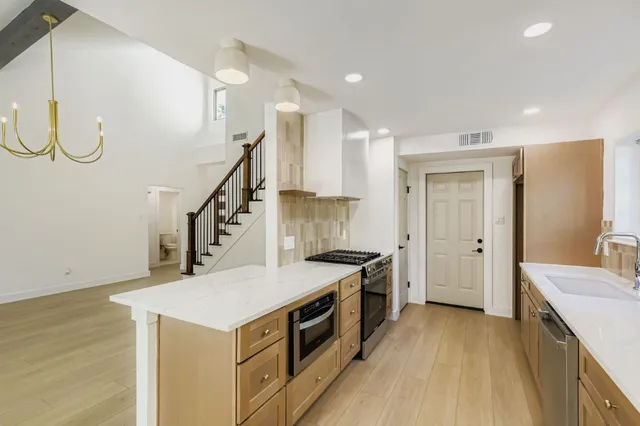 a kitchen with a stove a sink and a refrigerator
