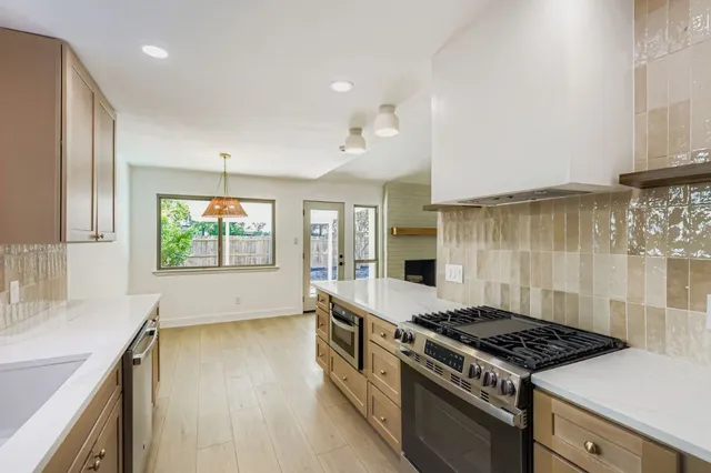 a kitchen with a stove and a sink