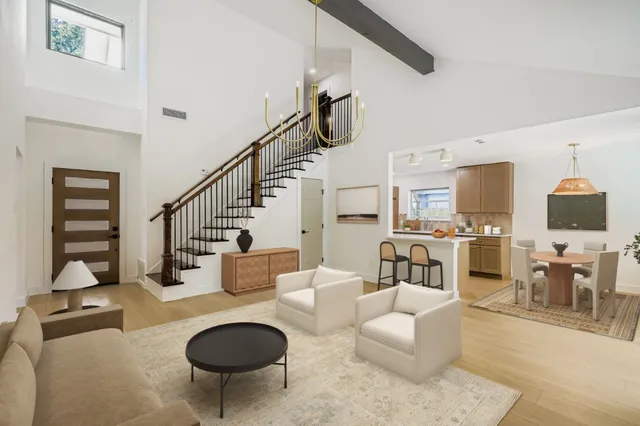 a living room with furniture a rug and white walls
