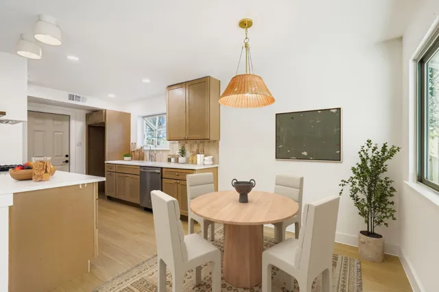 a kitchen with a table and chairs in it