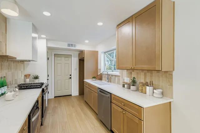 a kitchen with a sink stove and cabinets