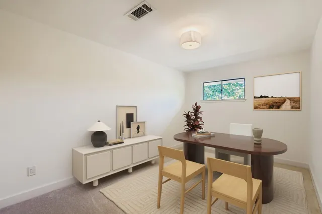 a dining room with furniture and window
