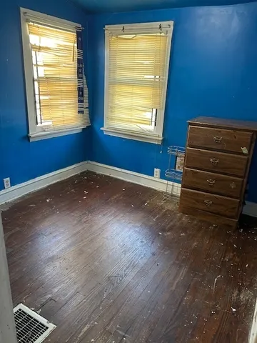 a view of room with window and wooden floor