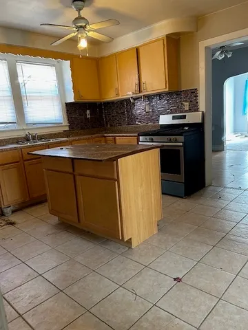 a kitchen with stainless steel appliances granite countertop a sink and a stove