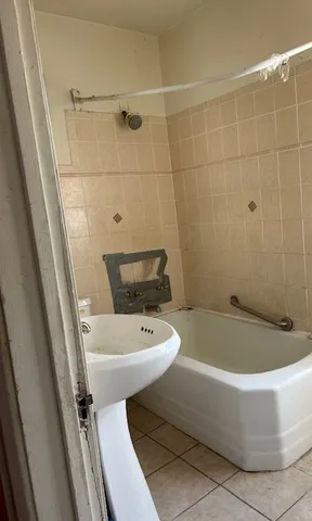 a bathroom with a sink a toilet and bathtub