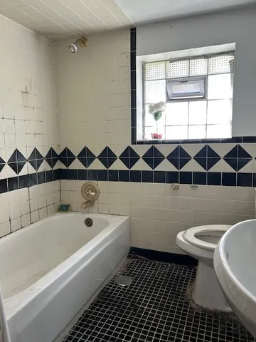 a bathroom with a bathtub and a toilet