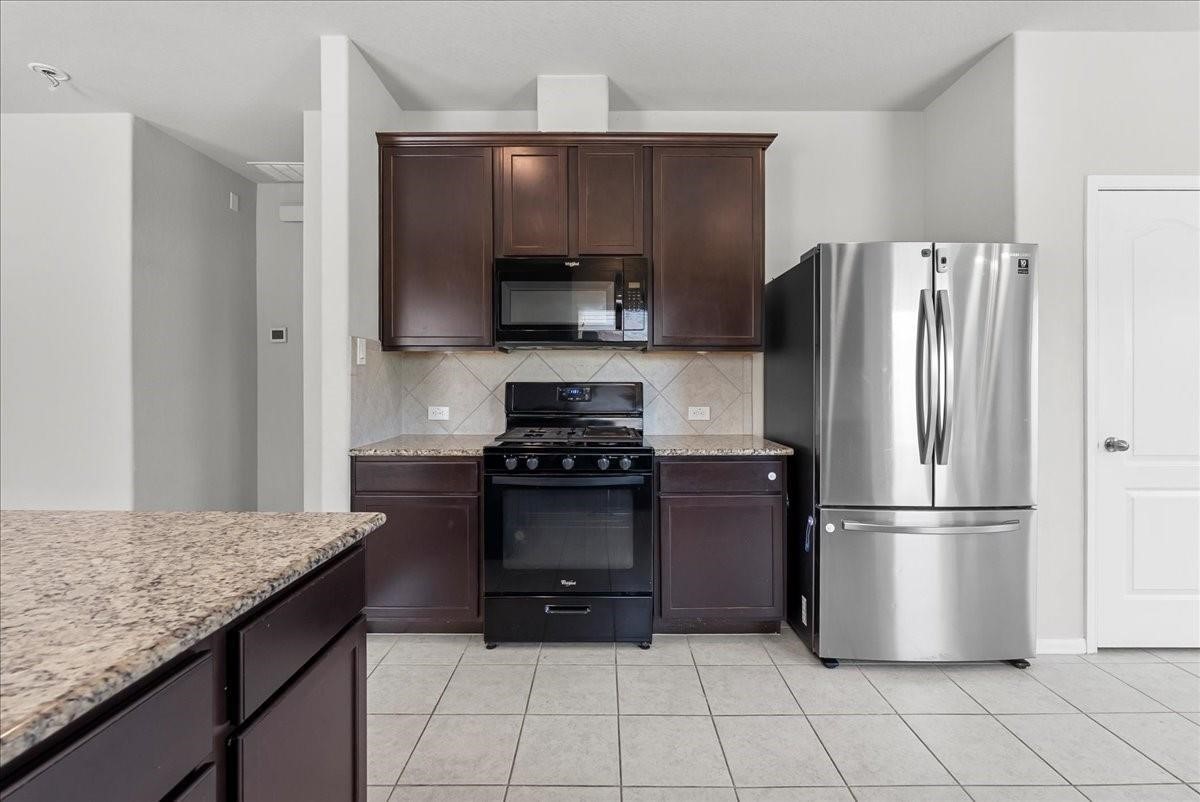5111 Bay Lane Bacliff, TX 77518 - Photo 17 of 48 a kitchen with a refrigerator and a sink