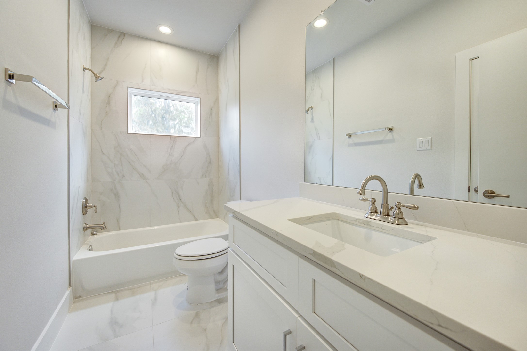 853 Mansfield Street, Unit A Houston, TX 77091 - Photo 10 of 16 a bathroom with a sink a toilet and shower
