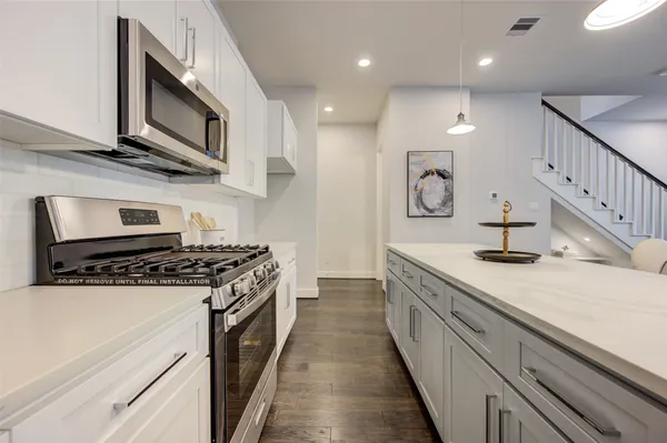 a kitchen with stainless steel appliances granite countertop a stove and a sink