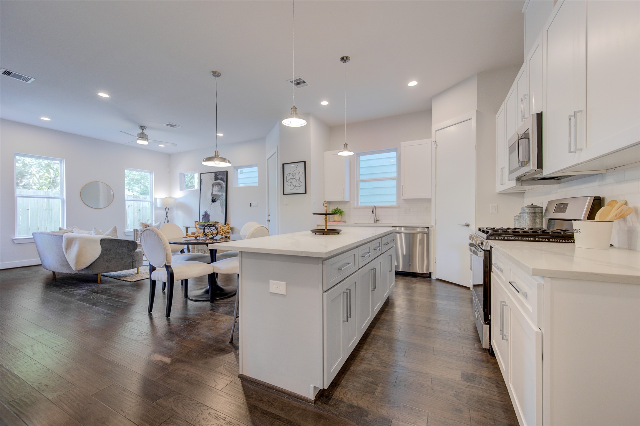 853 Mansfield Street, Unit A Houston, TX 77091 - Photo 2 of 16 a kitchen with counter top space a sink appliances and cabinets