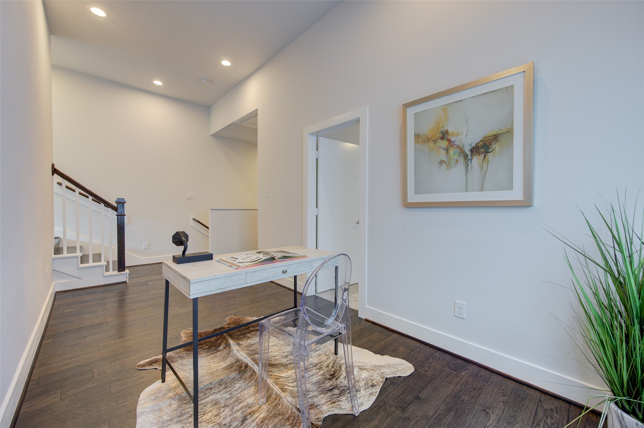 853 Mansfield Street, Unit A Houston, TX 77091 - Photo 8 of 16 a workspace with furniture and wooden floor