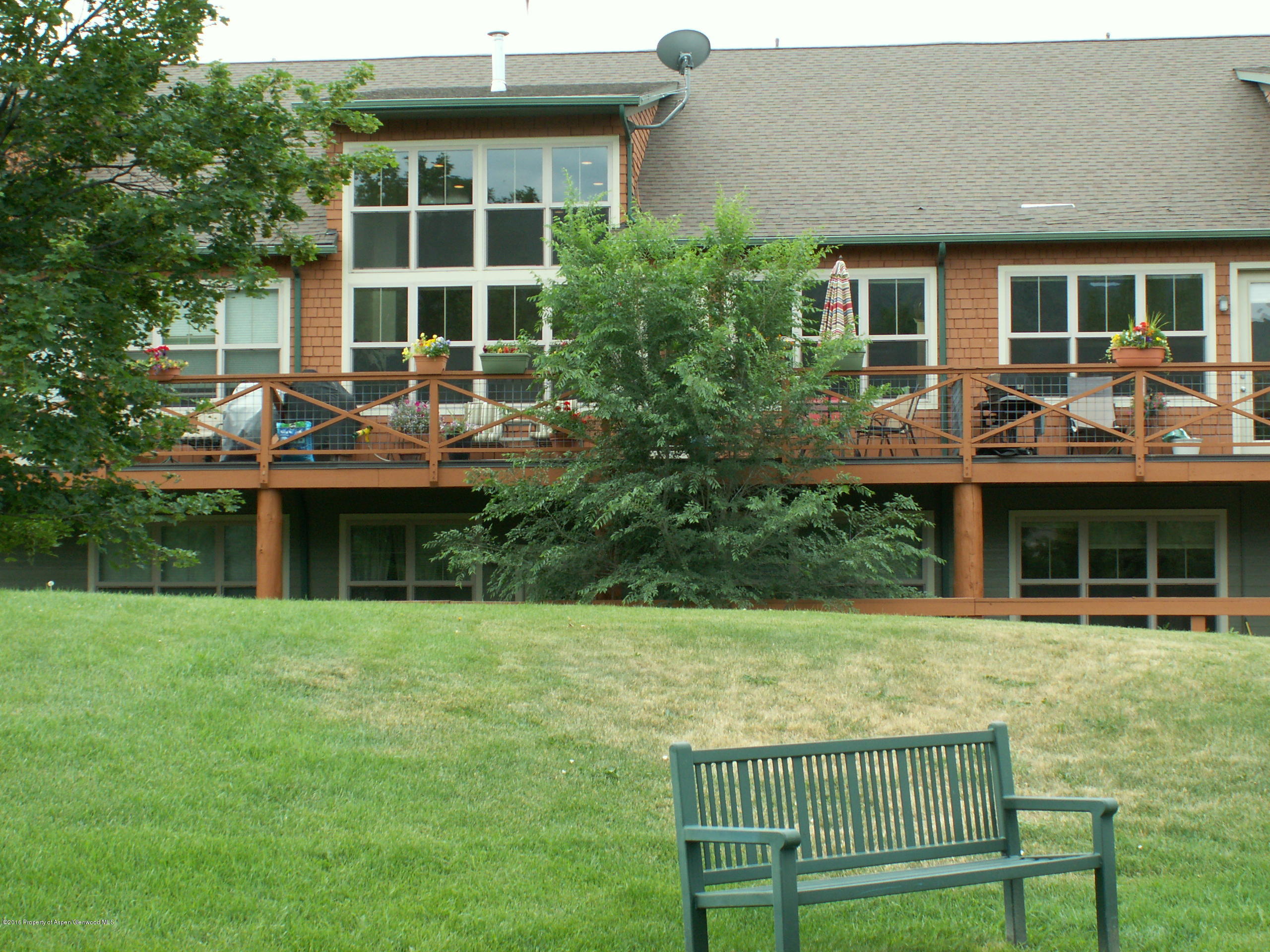 a view of a house with backyard and porch