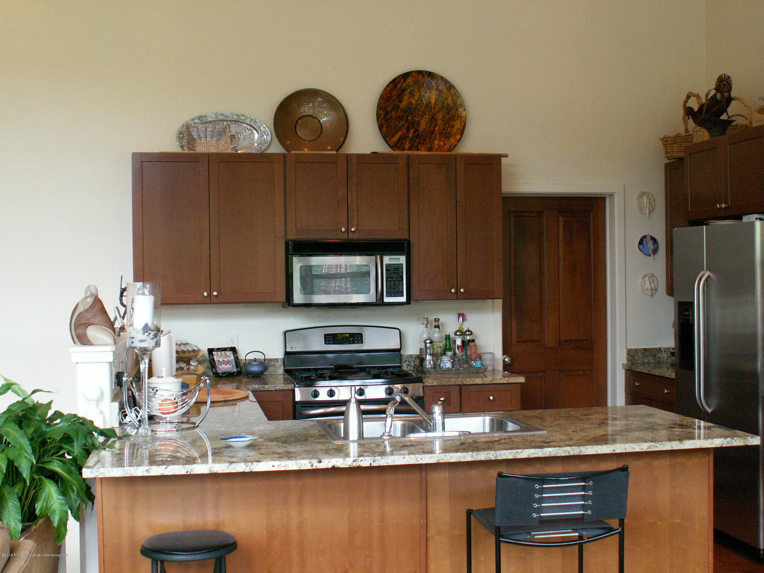413 Jody Road Basalt, CO 81621 - Photo 6 of 10 a kitchen with stainless steel appliances granite countertop a sink refrigerator stove and microwave