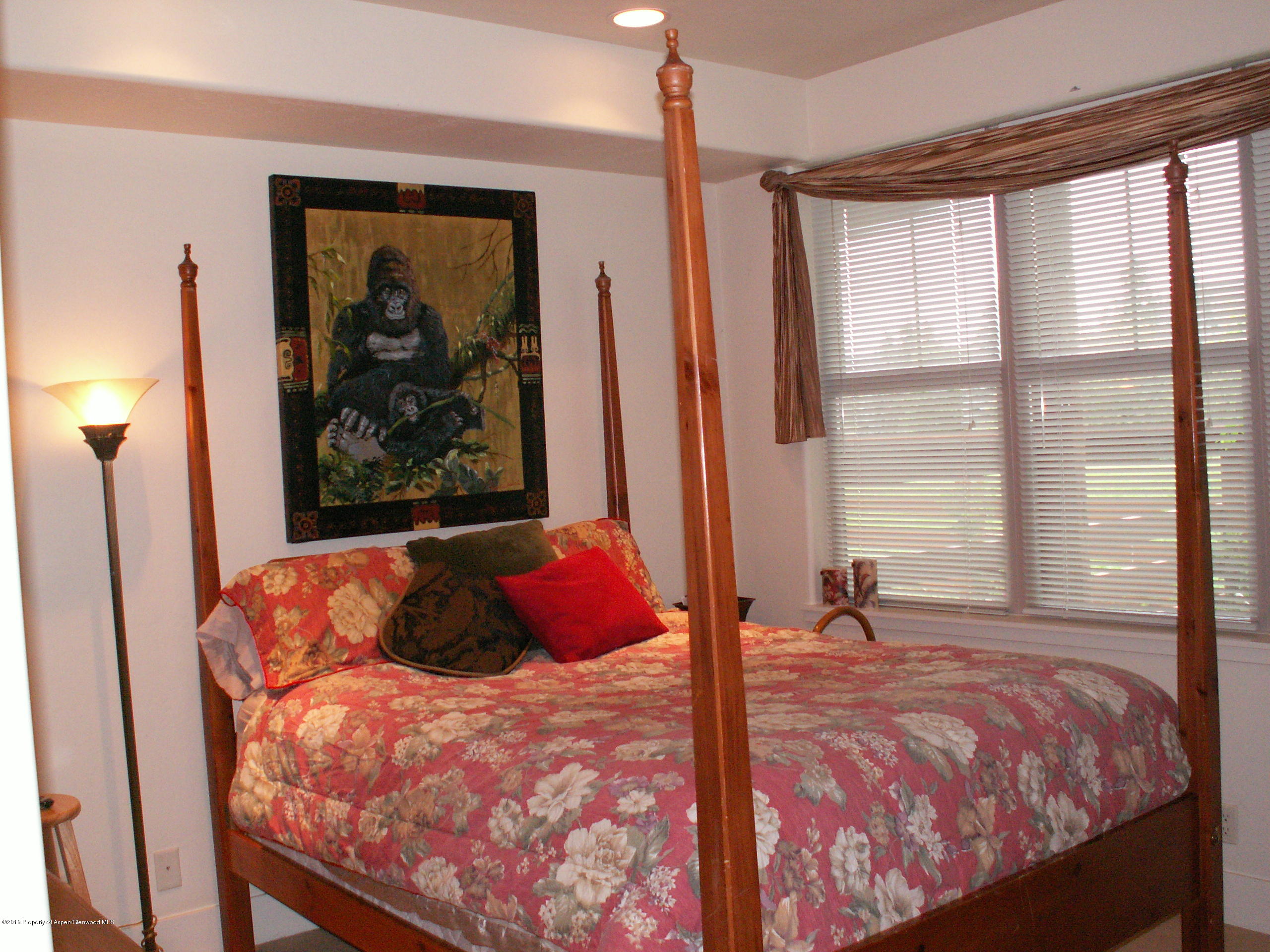 413 Jody Road Basalt, CO 81621 - Photo 8 of 10 a bedroom with a large bed and a large window