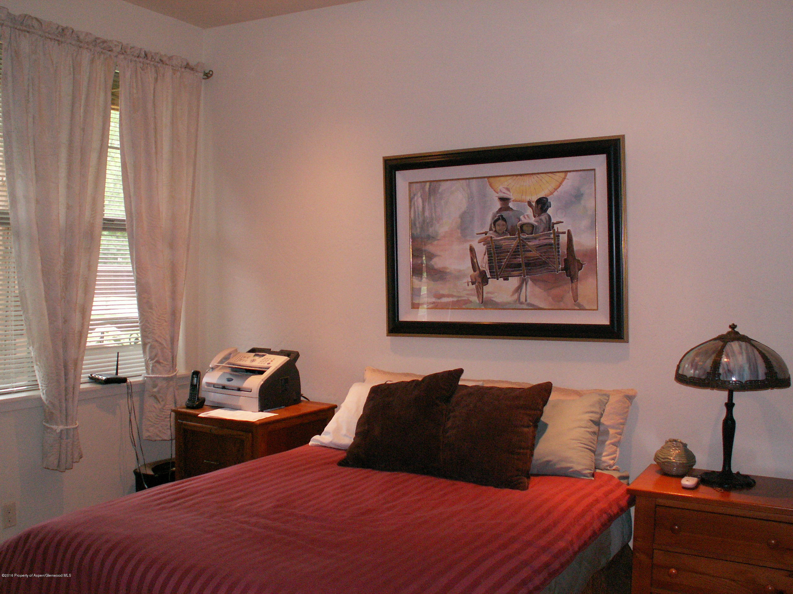 413 Jody Road Basalt, CO 81621 - Photo 9 of 10 a bedroom with a bed and a painting on the wall