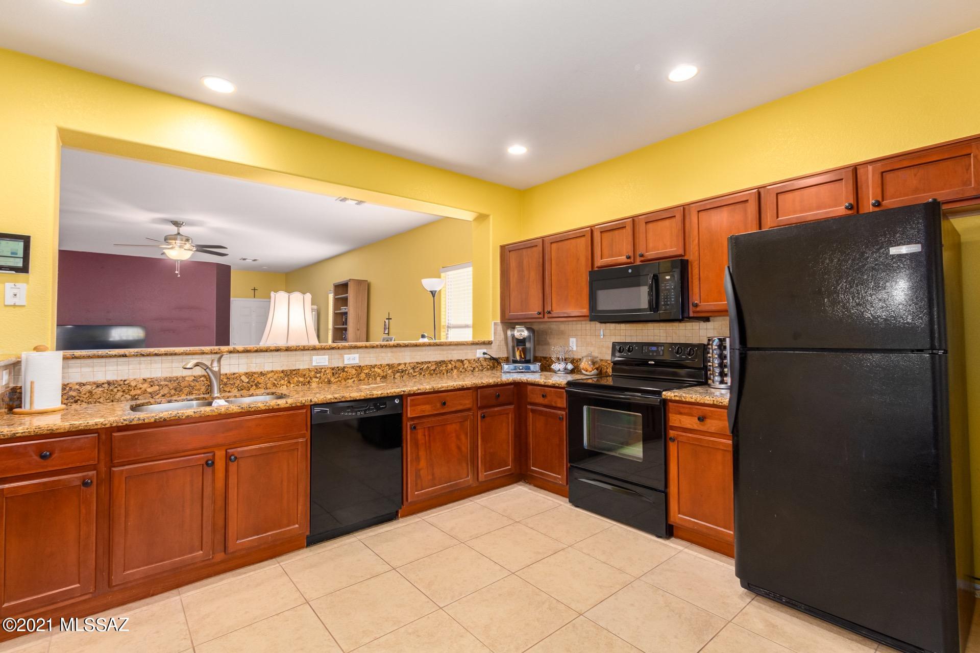 20894 East Founders Road Red Rock, AZ 85145 - Photo 10 of 27 a kitchen with stainless steel appliances granite countertop a refrigerator and a sink