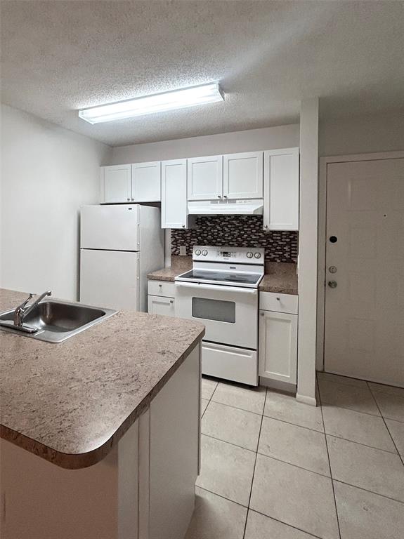 4481 West McNab Road, Unit 26 Pompano Beach, FL 33069 - Photo 6 of 13 a kitchen with a sink a stove and refrigerator