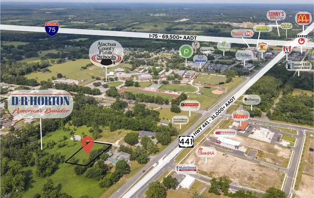 view of a balcony with two chairs and a table