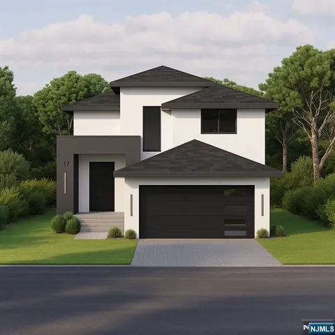 a front view of a house with a garden and garage