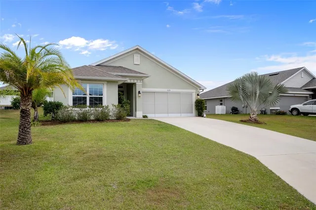 a front view of a house with a garden and outdoor seating