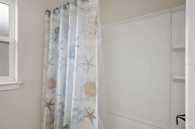 a bedroom with a bed and a lamp