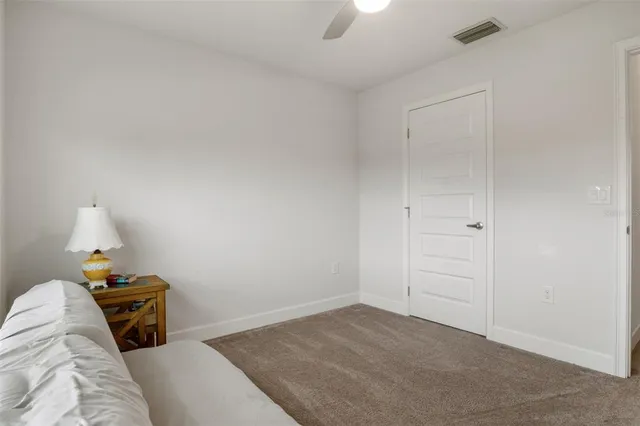 a bedroom with a bed and a large mirror