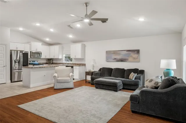 a kitchen with a refrigerator sink and cabinets