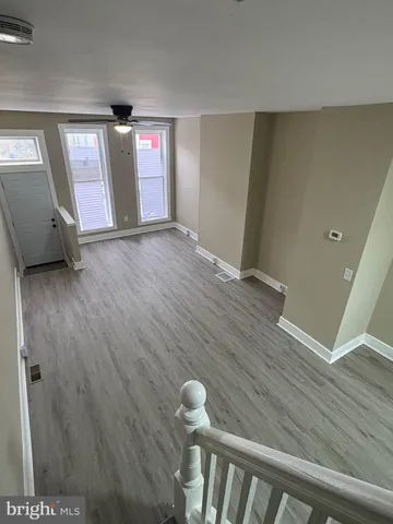 a view of an empty room with wooden floor