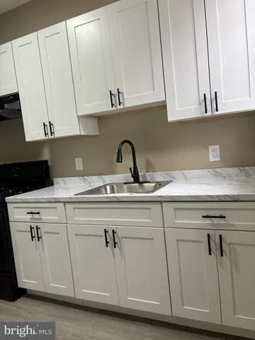 a kitchen with appliances cabinets and a sink