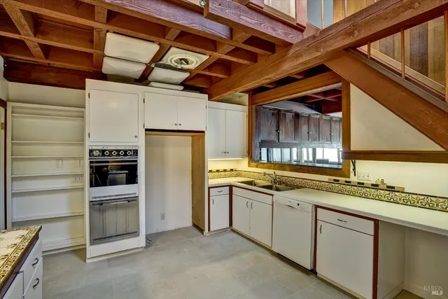 a kitchen with a sink cabinets and window