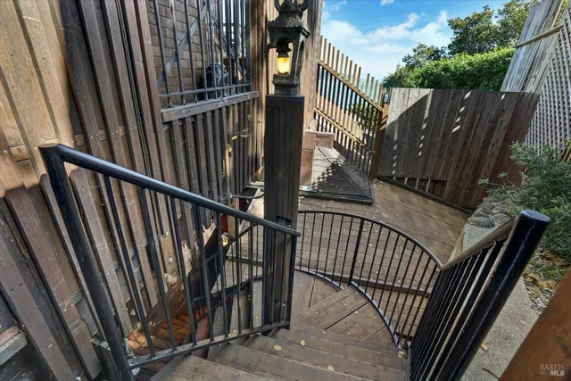 a view of balcony with wooden floor and fence